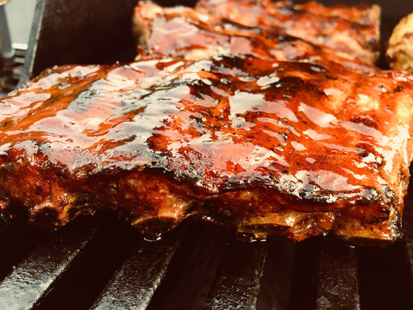 Ribs on the grill with Texas Pepper Jelly glaze on top.