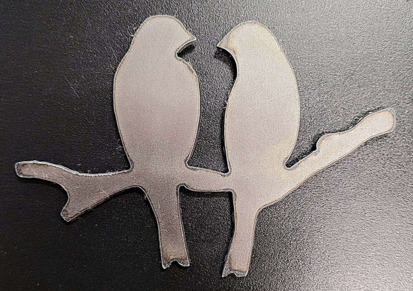 Two birds sitting on a branch raw metal cutout.
